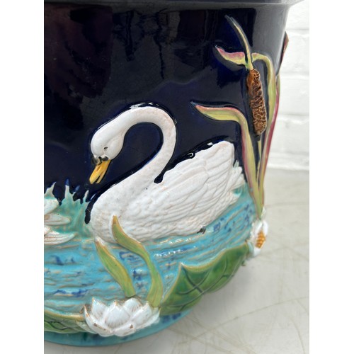 473 - A GEORGE JONES MAJOLICA JARDINIERE DECORATED WITH SWANS, 

37cm x 30cm