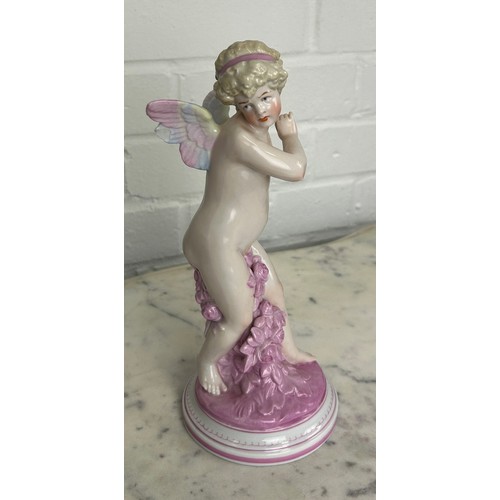 557 - A DRESDEN PORCELAIN FIGURE OF A PUTTI, 

25cm H