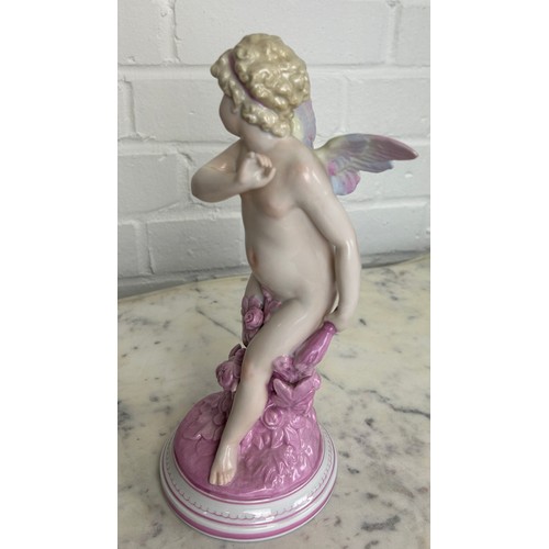 557 - A DRESDEN PORCELAIN FIGURE OF A PUTTI, 

25cm H