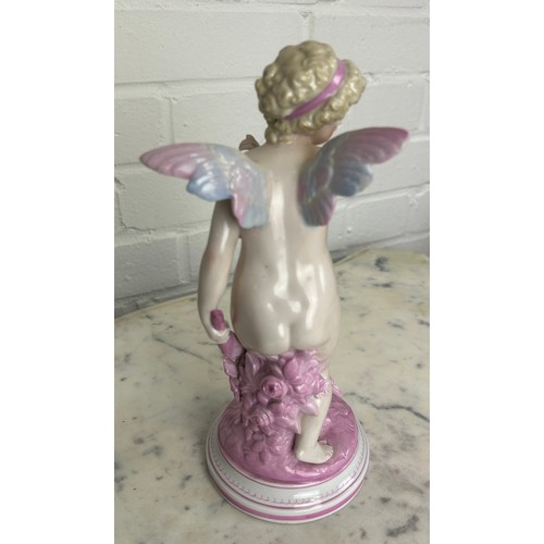 557 - A DRESDEN PORCELAIN FIGURE OF A PUTTI, 

25cm H