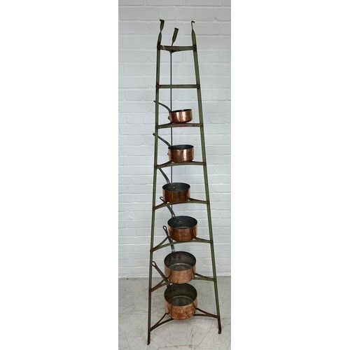 410B - A GRADUATED SET OF SIX COPPER PANS ON GREEN PAINTED IRON STAND, 

Stand 182cm H

Largest pan 22cm x ... 