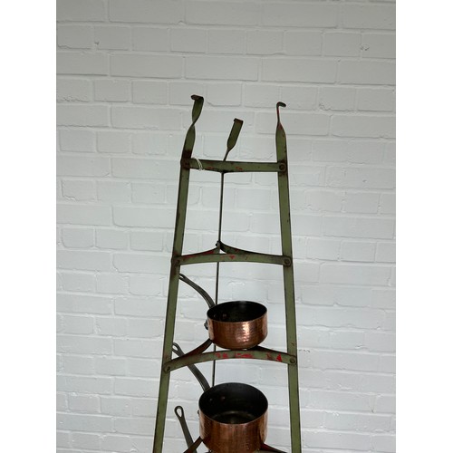 410B - A GRADUATED SET OF SIX COPPER PANS ON GREEN PAINTED IRON STAND, 

Stand 182cm H

Largest pan 22cm x ... 