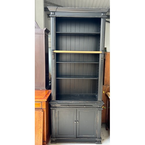 512 - A TALL EBONISED SECTIONAL BOOKCASE, 

240cm x 100cm x 40cm