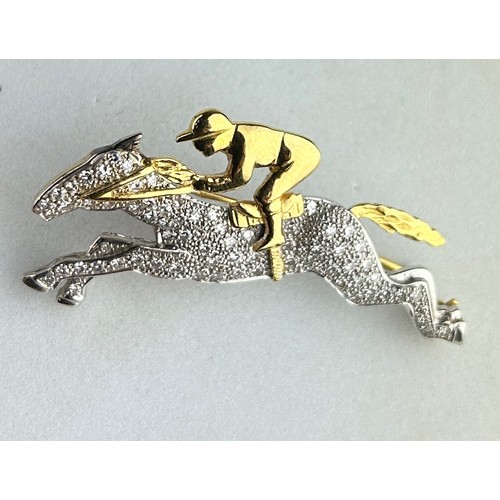 176 - AN 18CT GOLD AND DIAMOND HORSE AND JOCKEY BROOCH, 

The brooch measures 4.7cm x 2.4cm.