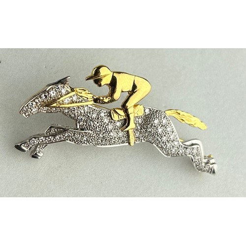 176 - AN 18CT GOLD AND DIAMOND HORSE AND JOCKEY BROOCH, 

The brooch measures 4.7cm x 2.4cm.