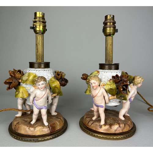 484 - A PAIR OF DRESDEN PORCELAIN TABLE LAMPS, DEPICTING WINGED PUTTI, FLORA AND FAUAN, 

29cm H each.