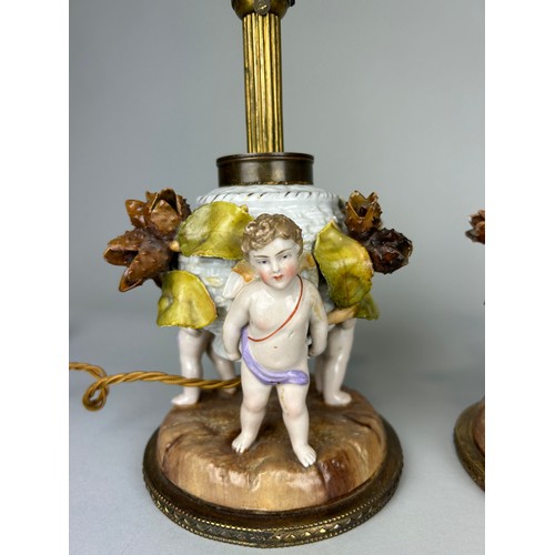 484 - A PAIR OF DRESDEN PORCELAIN TABLE LAMPS, DEPICTING WINGED PUTTI, FLORA AND FAUAN, 

29cm H each.