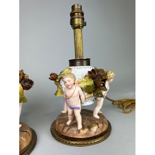 484 - A PAIR OF DRESDEN PORCELAIN TABLE LAMPS, DEPICTING WINGED PUTTI, FLORA AND FAUAN, 

29cm H each.