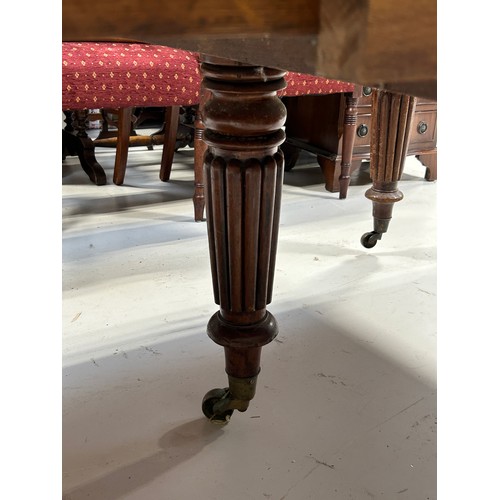 444 - A LARGE WILLIAM IV DINING TABLE WITH TWO LEAFS RAISED ON TURNED LEGS AND CASTORS,

225cm x 120cm x 7... 