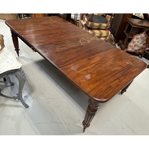 444 - A LARGE WILLIAM IV DINING TABLE WITH TWO LEAFS RAISED ON TURNED LEGS AND CASTORS,

225cm x 120cm x 7... 