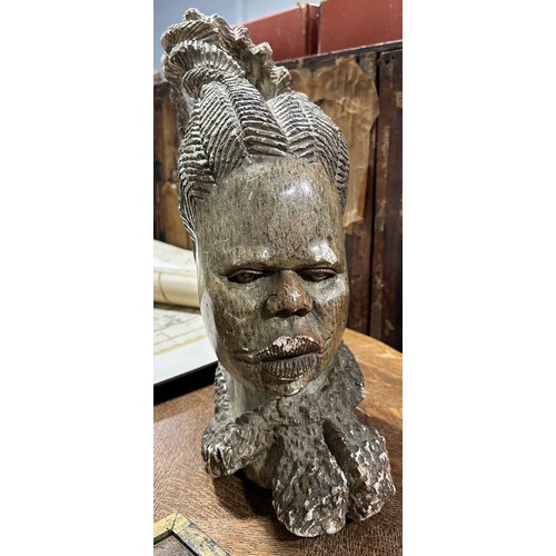 559 - AN AFRICAN HARDSTONE SCULPTURE OF A LADY'S HEAD, 

37cm H