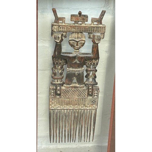 522 - AN ANTIQUE AFRICAN BRONZE COMB, 

30cm x 10cm 

Mounted in a glass display case and glazed.
56cm x 3... 