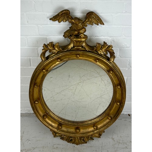 440B - A GILT CIRCULAR WALL MIRROR WITH CARVED FRAME IN THE FRENCH IMPERIAL STYLE,