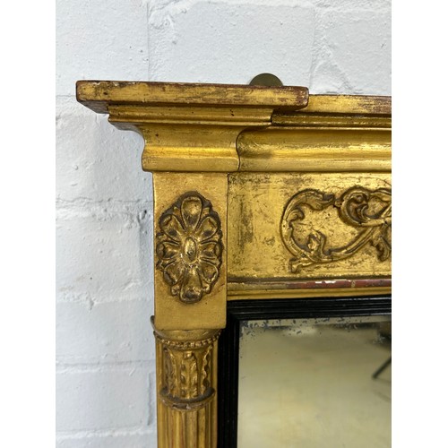 439 - A REGENCY GILT WOOD WALL MIRROR, 

73cm x 55cm

Corinthian columns, with carved oval patera.