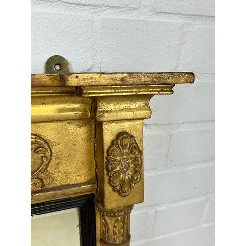 439 - A REGENCY GILT WOOD WALL MIRROR, 

73cm x 55cm

Corinthian columns, with carved oval patera.