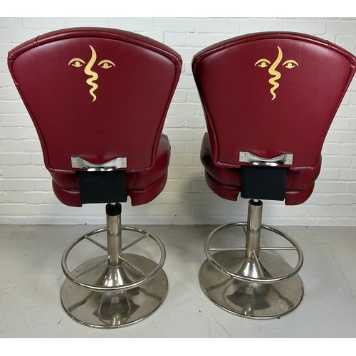 607B - A PAIR OF POKER SWIVEL STOOLS UPHOLSTERED IN RED FABRIC WITH PICASSO STYLE FACES IN YELLOW TO BACKS ... 