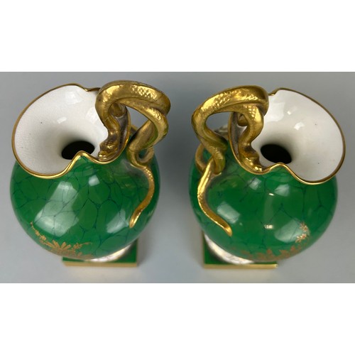 35 - A PAIR OF ROYAL WORCESTER GREEN PAINTED PEDESTAL VASES BY RICHARD SEBRIGHT WITH GILT SERPENT HANDLES... 