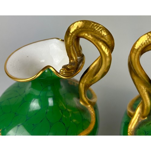 35 - A PAIR OF ROYAL WORCESTER GREEN PAINTED PEDESTAL VASES BY RICHARD SEBRIGHT WITH GILT SERPENT HANDLES... 