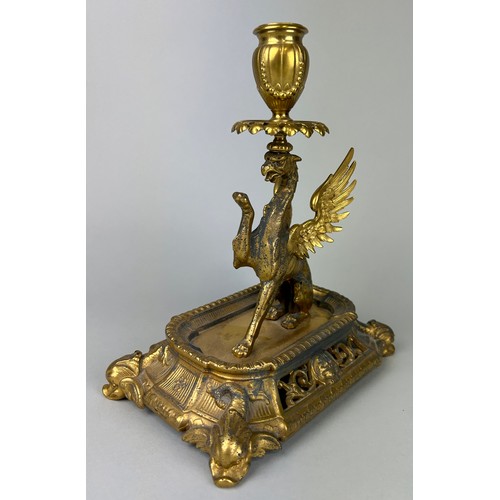 29 - A GILT METAL CANDLESTICK IN THE FORM OF A PHOENIX,

25cm x 22cm