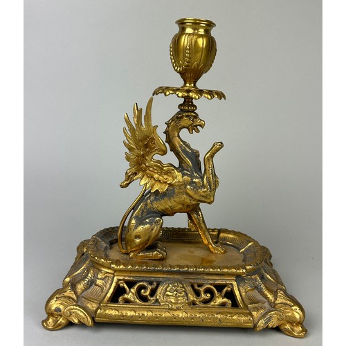 29 - A GILT METAL CANDLESTICK IN THE FORM OF A PHOENIX,

25cm x 22cm