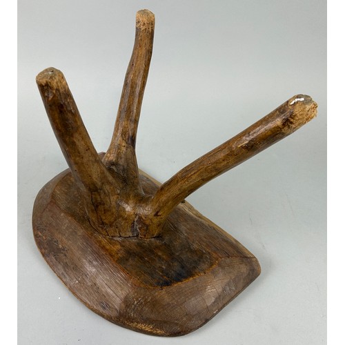 425 - A PRIMITIVE OAK MILKING STOOL ON THREE LEGS, 

34cm x 27cm