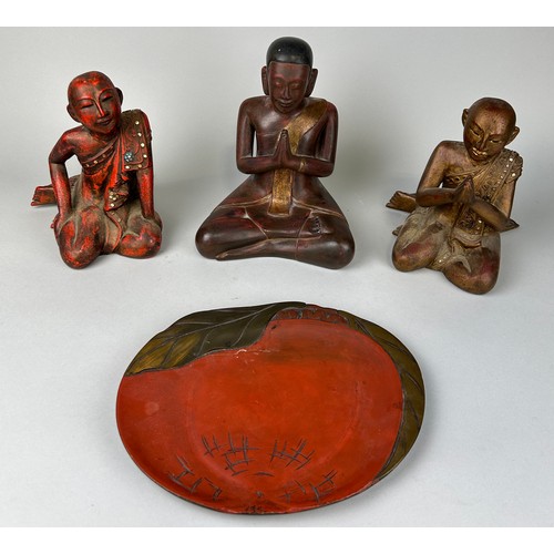 64 - A GROUP OF THREE CARVED WOODEN BUDDHA'S ALONG WITH A RED AND BLACK LACQUERED TRAY, 

Largest Buddha ... 