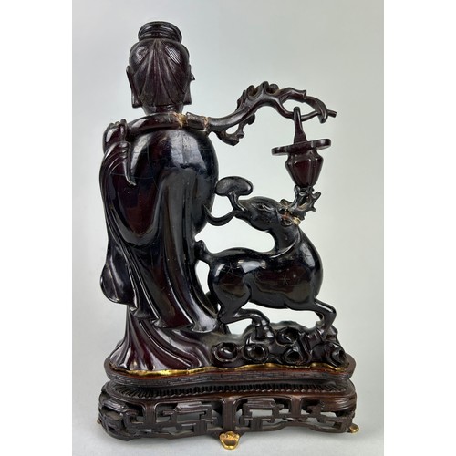 59 - A CHINESE AMBER STATUE DEPICTING HSI WANG MU, 

Accompanied by a letter, written in French along wit... 