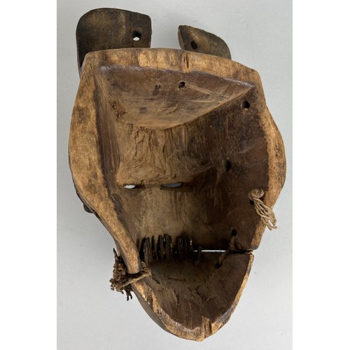 194 - A WOODEN TRIBAL MASK, 

25cm x 18cm