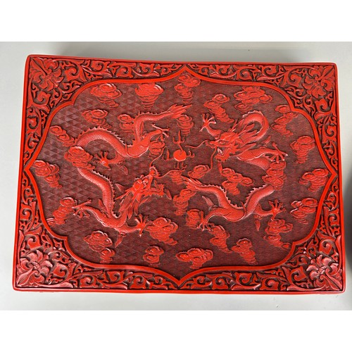 254 - A CHINESE RED LACQUERED CINNABAR BOX ALONG WITH A SIMILAR CIRCULAR PLATE (2), 

Box 39cm x 29cm 

Pl... 