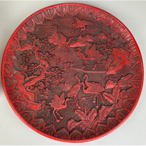 254 - A CHINESE RED LACQUERED CINNABAR BOX ALONG WITH A SIMILAR CIRCULAR PLATE (2), 

Box 39cm x 29cm 

Pl... 