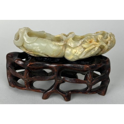 76 - A CHINESE JADE MOUNTED ON ROSEWOOD STAND, 

Jade measures 12cm x 5cm