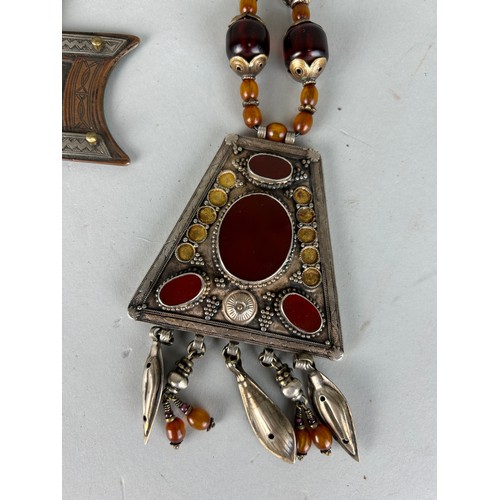 187 - A MOROCCAN TUAREG 'VAIL WEIGHT' ALONG WITH A CARNELIAN AND WHITE METAL NECKLACE, 

Longest 36cm