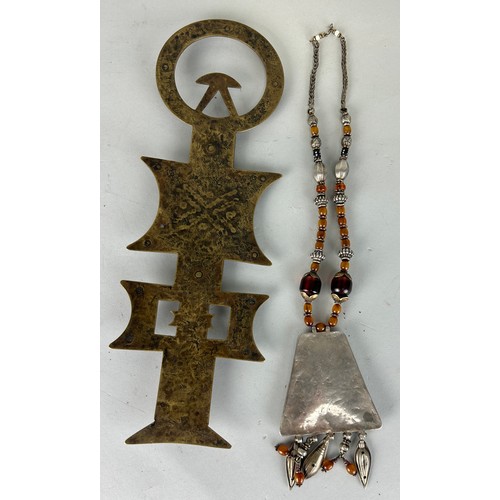 187 - A MOROCCAN TUAREG 'VAIL WEIGHT' ALONG WITH A CARNELIAN AND WHITE METAL NECKLACE, 

Longest 36cm