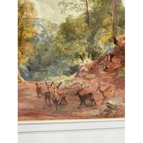 320 - A WATERCOLOUR PAINTING ON PAPER DEPICTING A GROUP OF DEER OR STAGS WALKING IN WOODLANDS, 

Inscribed... 