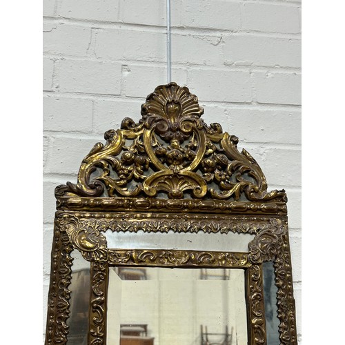 443 - A DUTCH BRASS REPOUSSE CUSHION WALL MIRROR POSSIBLY 18TH CENTURY, 

58cm x 32cm x 4cm