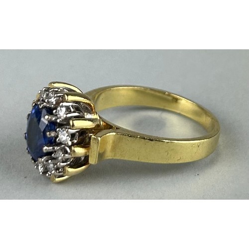 165 - A LADIES 18CT GOLD RING SET WITH A SAPPHIRE SURROUNDED BY DIAMONDS, 

Weight: 10.4gms