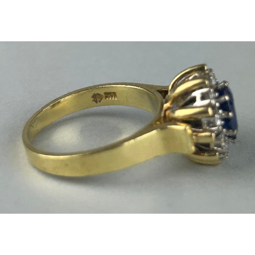 165 - A LADIES 18CT GOLD RING SET WITH A SAPPHIRE SURROUNDED BY DIAMONDS, 

Weight: 10.4gms