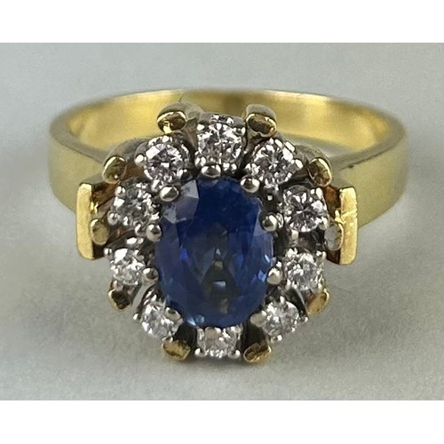 165 - A LADIES 18CT GOLD RING SET WITH A SAPPHIRE SURROUNDED BY DIAMONDS, 

Weight: 10.4gms