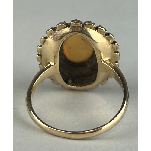 170 - A GOLD RING SET WITH A CENTRAL OPAL SURROUNDED BY DIAMONDS, RUBIES AND SMALL OPALS, 

Weight: 6.7gms