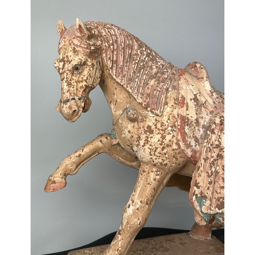 1 - A CHINESE TANG STYLE TERRACOTTA HORSE WITH TRACES OF PIGMENT, 

48cm x 38cm x 14cm

Sitting on a woo... 