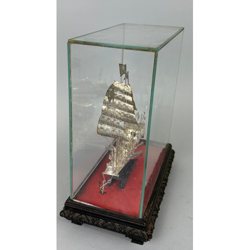 141 - A CHINESE SILVER JUNK SHIP IN PERSPEX CASE, 

21cm x 17cm