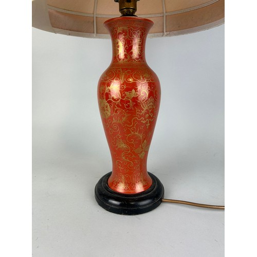 84 - AN EARLY 20TH CENTURY RED AND GILT CHINESE VASE ADAPTED FOR A LAMP, 

39cm H

With shade 63cm.