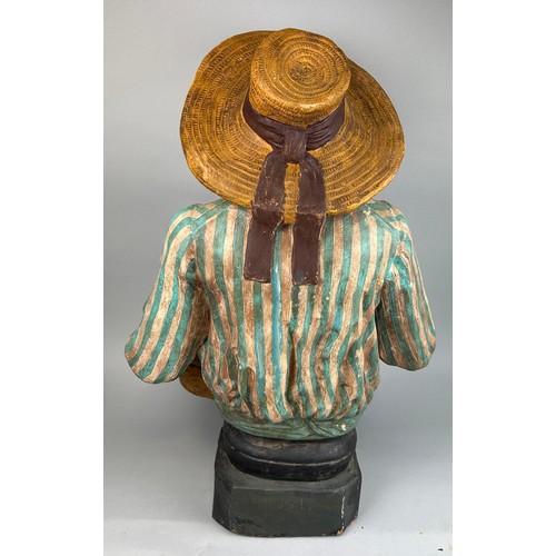 436 - AFTER GOLDSHEIDER: A LARGE AND HEAVY PAINTED TERRACOTTA FIGURE OF A GENTLEMAN WEARING A HAT, HOLDING... 