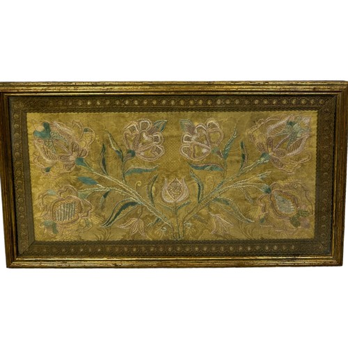 265 - AN 18TH OR 19TH CENTURY SILK EMBROIDERY OF FLOWERS, 

Mounted in a frame and glazed. 

53cm x 29cm