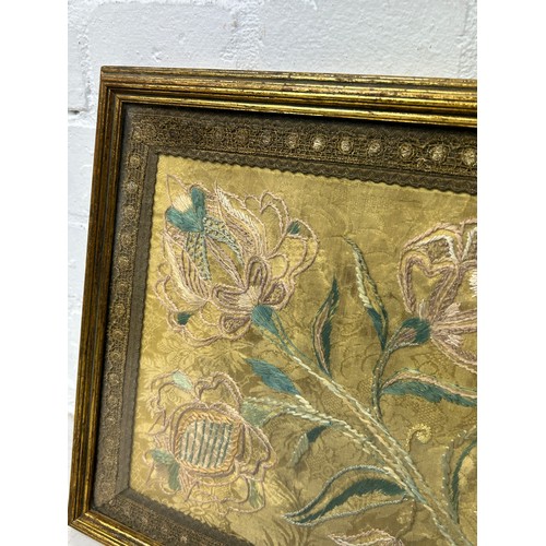 265 - AN 18TH OR 19TH CENTURY SILK EMBROIDERY OF FLOWERS, 

Mounted in a frame and glazed. 

53cm x 29cm