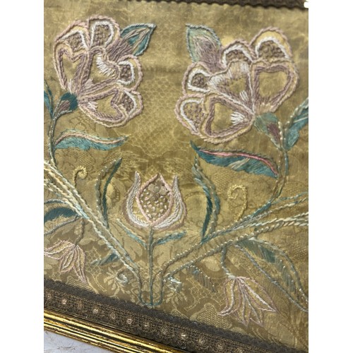 265 - AN 18TH OR 19TH CENTURY SILK EMBROIDERY OF FLOWERS, 

Mounted in a frame and glazed. 

53cm x 29cm