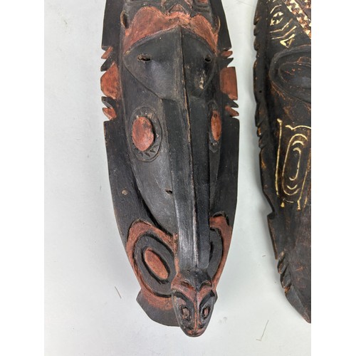 199 - A GROUP OF THREE OCEANIC PAINTED WOODEN MASKS, 

Largest 48cm L