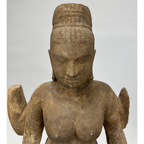 261 - A CAMBODIAN STONE FIGURE OF A DEITY, 

46cm x 26cm 

On wooden base with metal prongs. 

53cm H