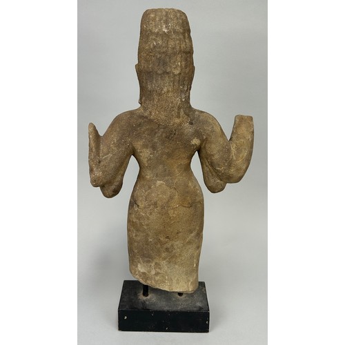 261 - A CAMBODIAN STONE FIGURE OF A DEITY, 

46cm x 26cm 

On wooden base with metal prongs. 

53cm H