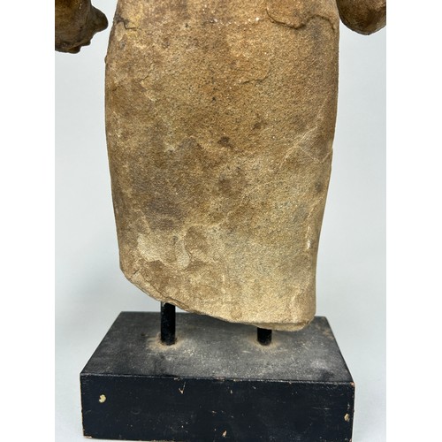 261 - A CAMBODIAN STONE FIGURE OF A DEITY, 

46cm x 26cm 

On wooden base with metal prongs. 

53cm H